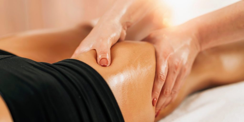 Anti cellulite female thigh massage at a beauty spa salon. Body care concept.