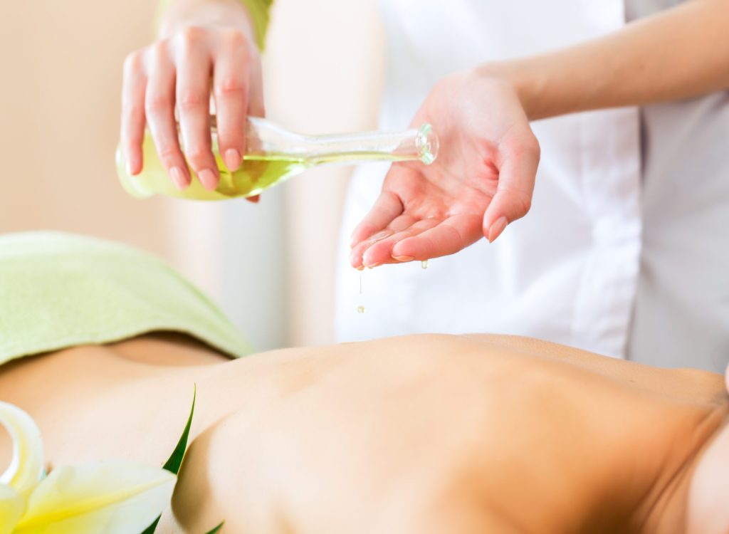 Beautiful woman having a wellness back massage and feeling visibly good about it